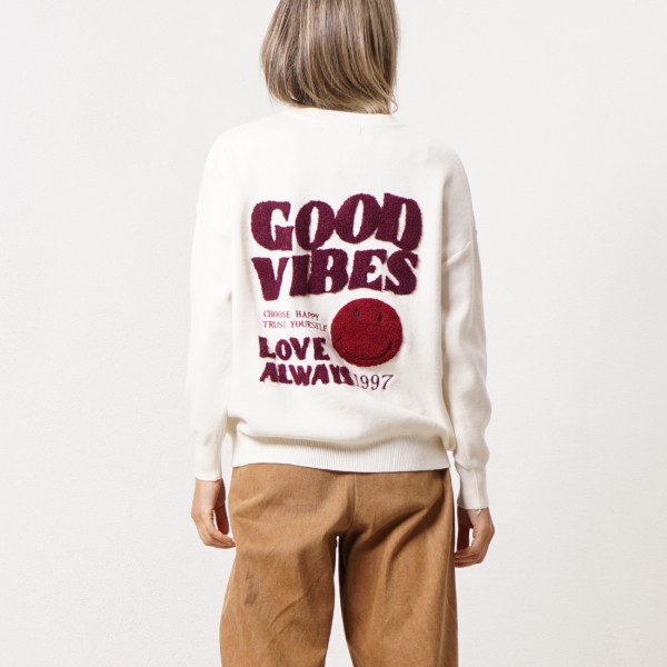Knitted sweater with embroidered appliqués