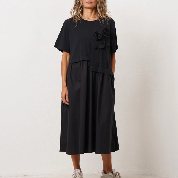 Dress with a mix of fabrics and flower appliqué