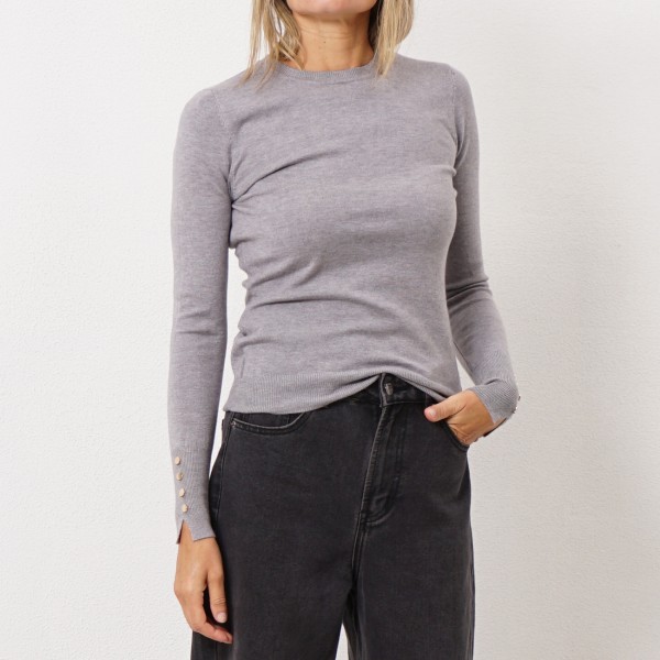 knitted sweater with gold buttons on the cuff