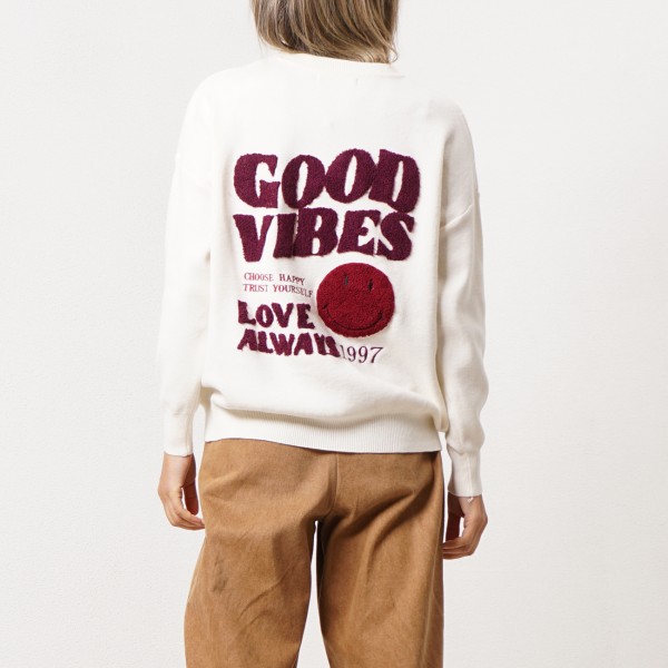 Knitted sweater with embroidered appliqués