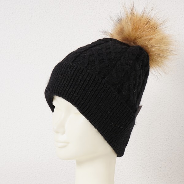Beanie with twisted details and natural pompom